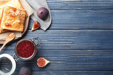 Photo of Flat lay composition with delicious fig jam on blue wooden table. Space for text