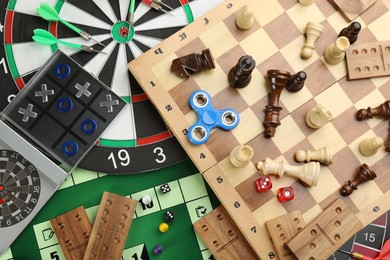 Different types of board games and its' components as background, top view