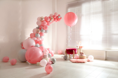 Room decorated with colorful balloons for party