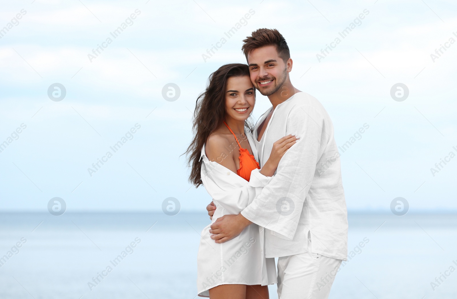 Photo of Happy young couple spending time together on beach