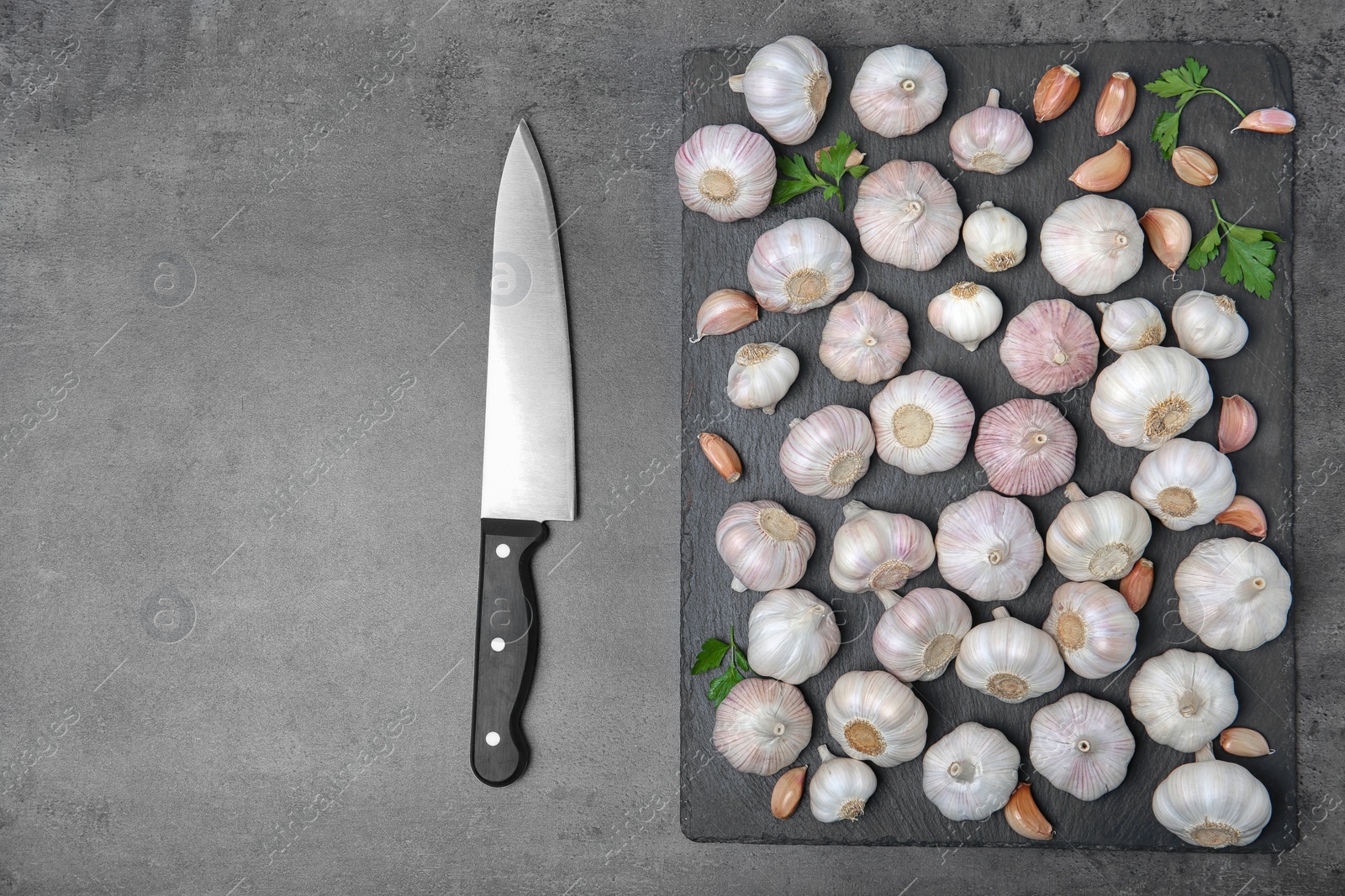 Photo of Flat lay composition with garlic on grey background