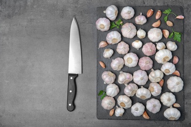 Flat lay composition with garlic on grey background