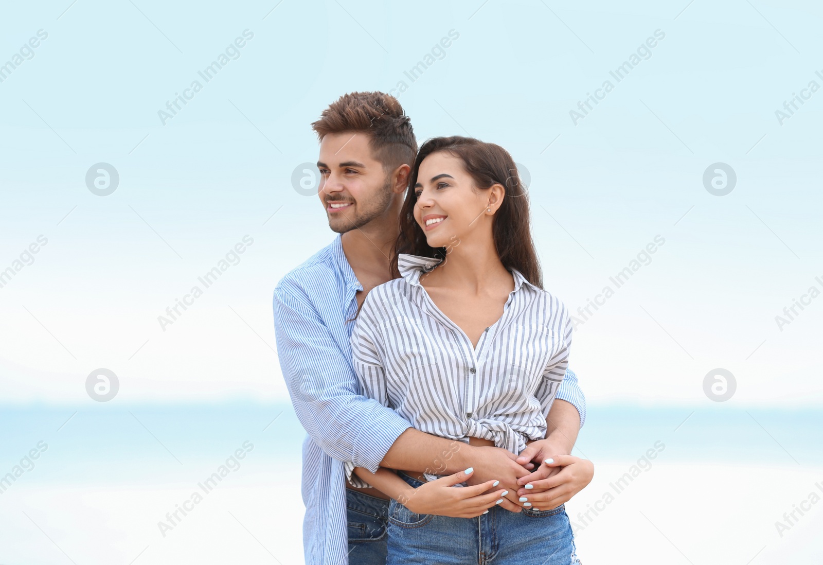 Photo of Happy young couple spending time together on beach