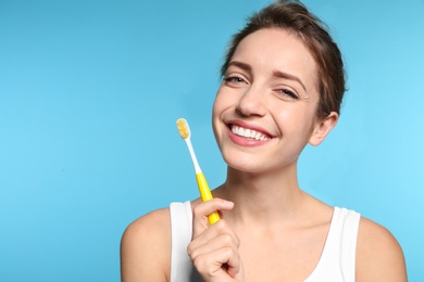 Photo of Portrait of young woman with toothbrush on color background. Space for text
