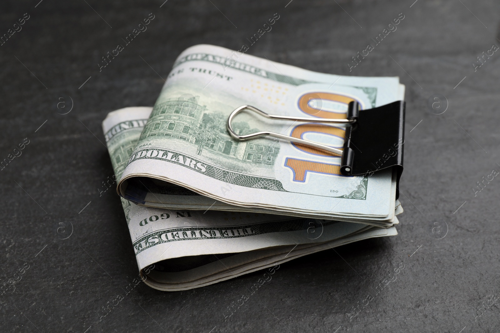 Photo of Many dollar banknotes on black table, closeup. American national currency