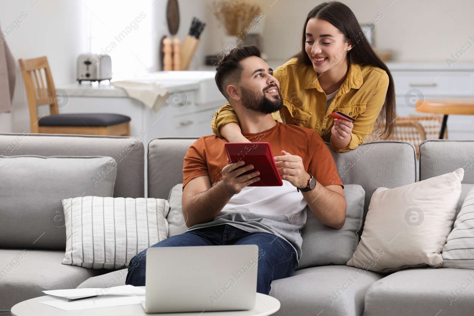 Photo of Young couple discussing family budget at home