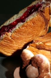 Photo of Round croissant with jam on plate, closeup. Tasty puff pastry