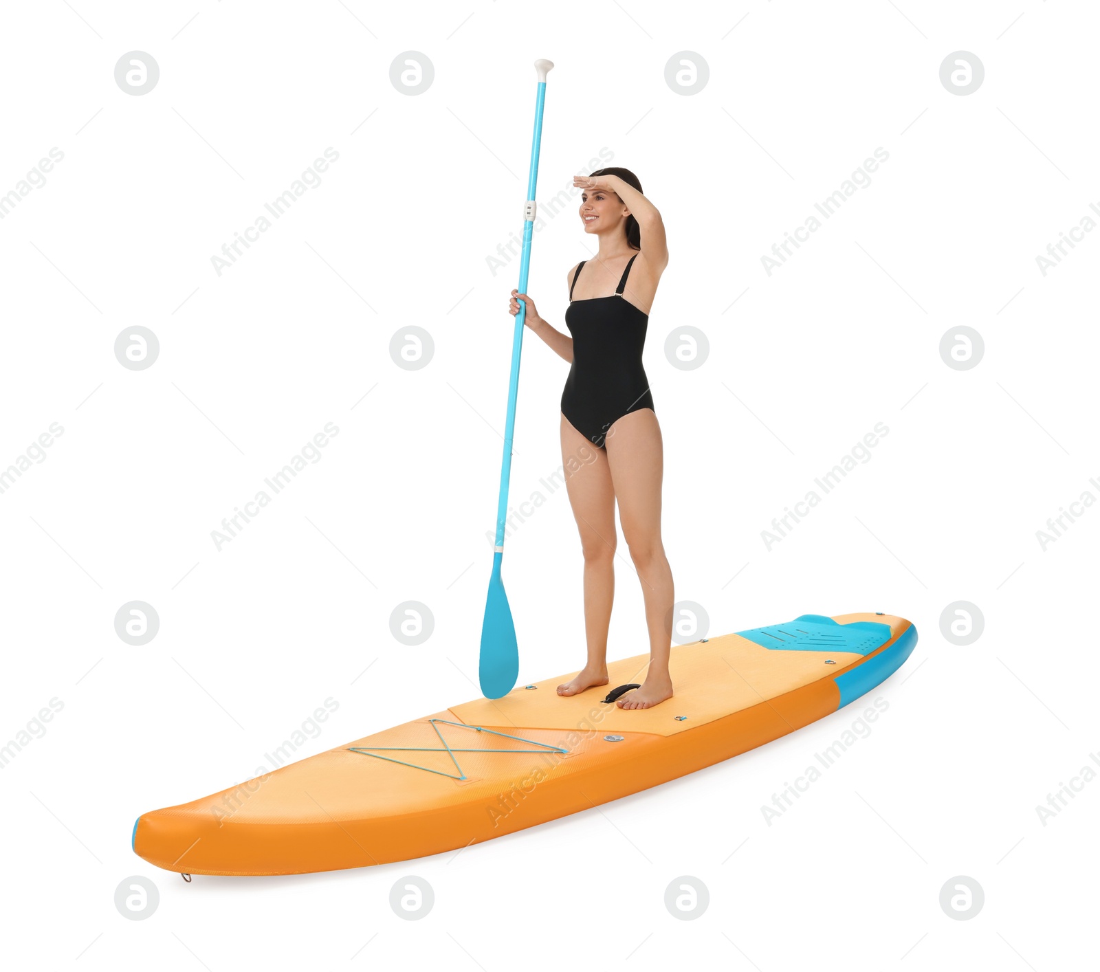 Photo of Happy woman with paddle on orange SUP board against white background