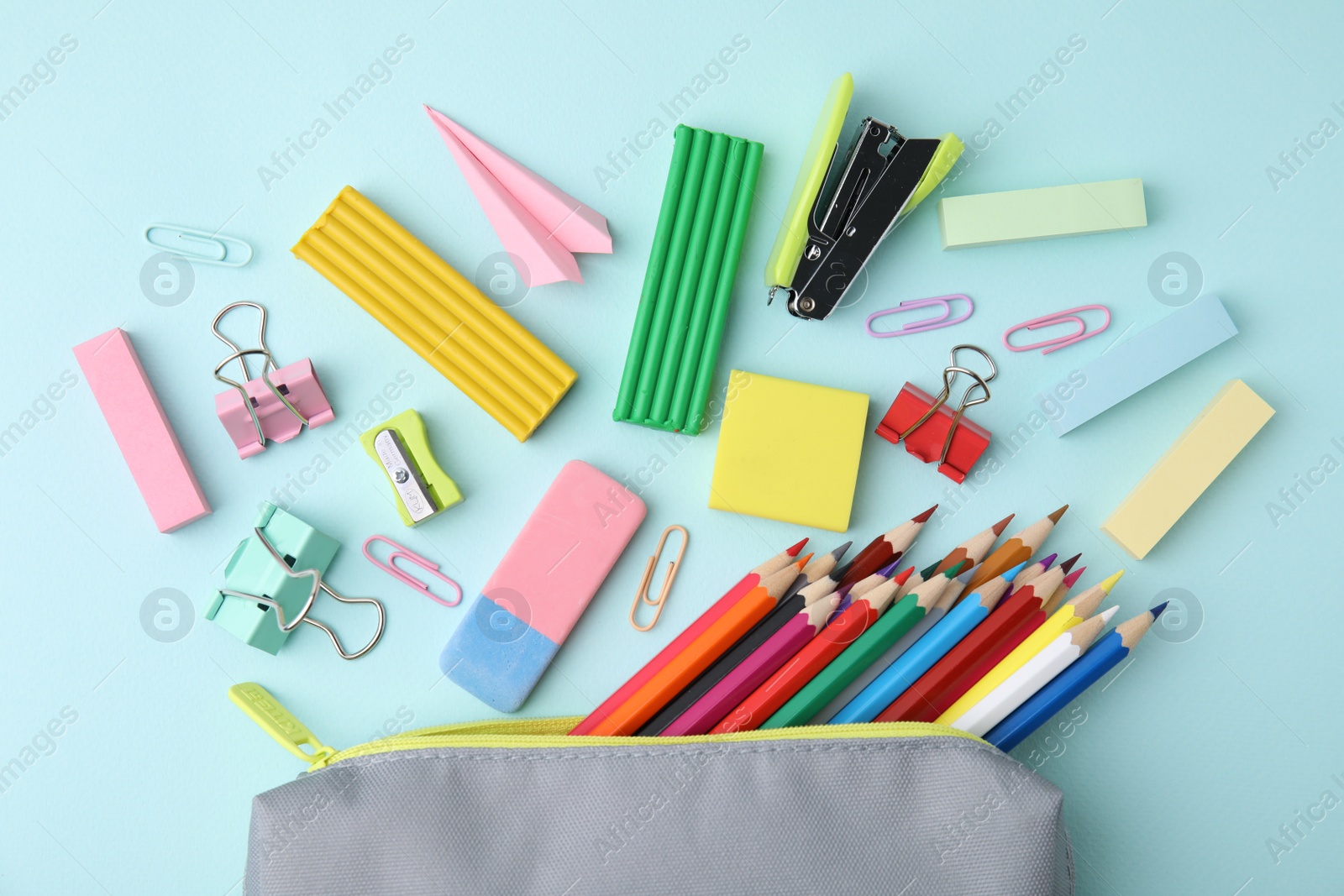 Photo of Flat lay composition with school stationery on light blue background. Back to school