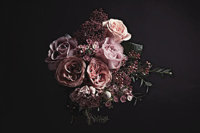 Photo of Beautiful bouquet on black background. Floral card design with dark vintage effect