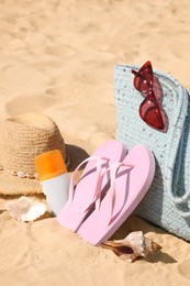 Photo of Bag and beach accessories on soft sand