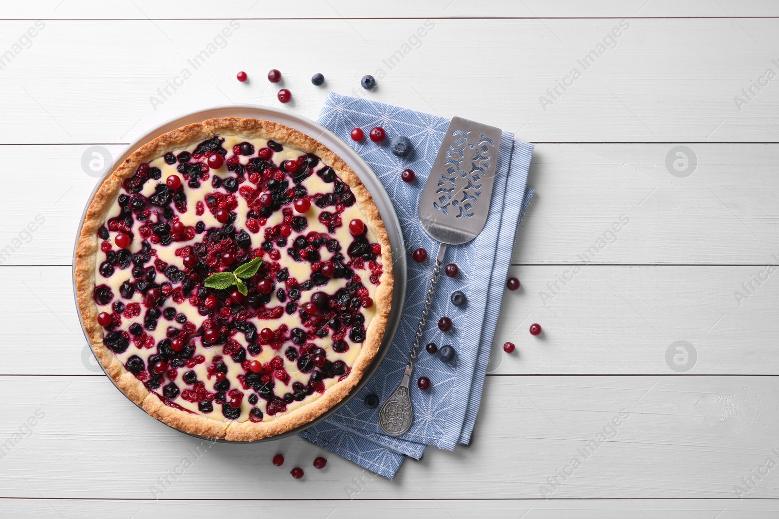 Photo of Delicious currant pie and fresh berries on white wooden table, flat lay