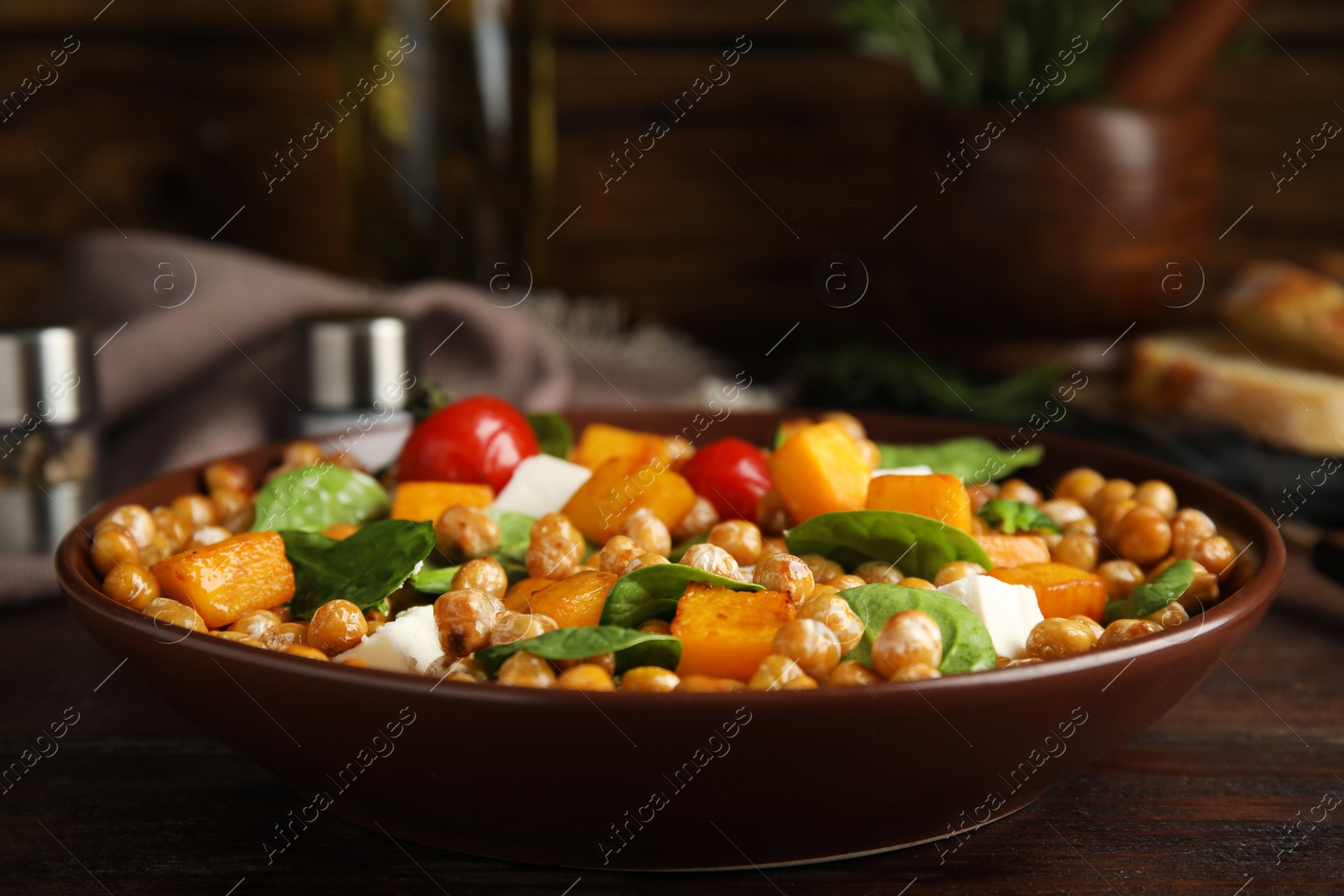 Photo of Delicious fresh chickpea salad on wooden table