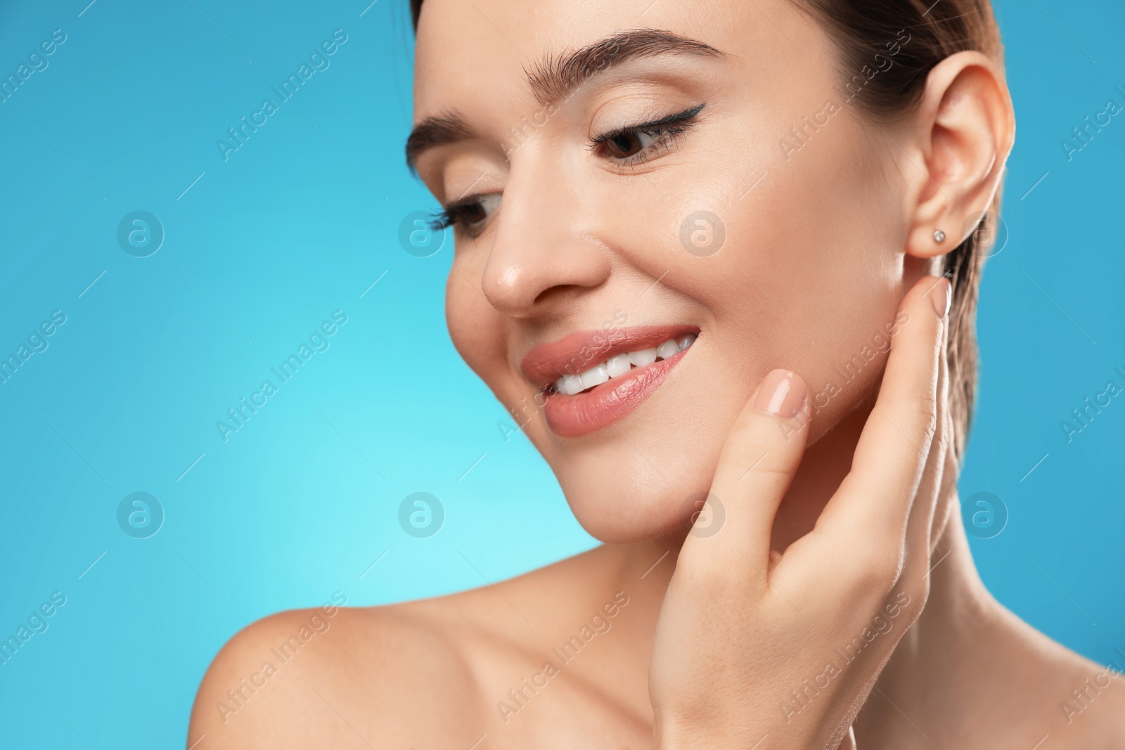 Photo of Beautiful woman with perfect smooth skin on light blue background, closeup