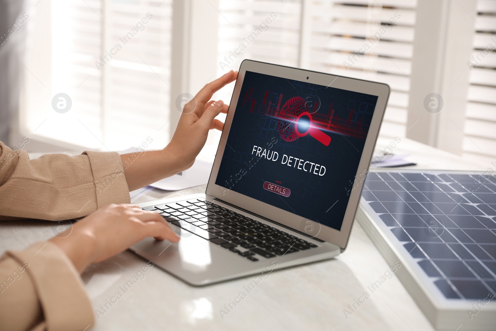 Image of Fraud prevention security system. Woman using laptop at white table, closeup