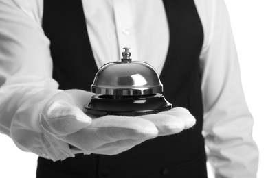 Photo of Butler holding service bell on white background, closeup