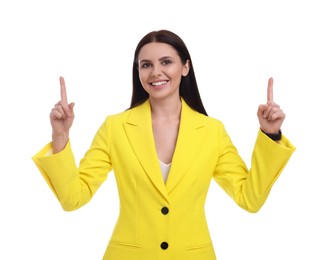 Photo of Beautiful happy businesswoman in yellow suit pointing at something on white background
