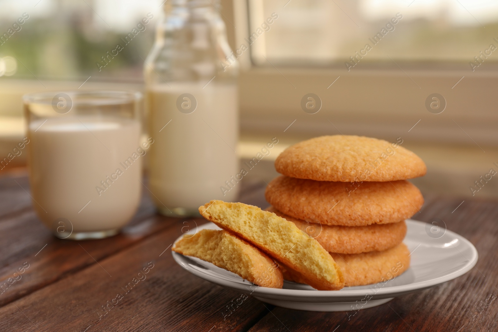 Photo of Delicious Danish butter cookies on wooden table, closeup. Space for text