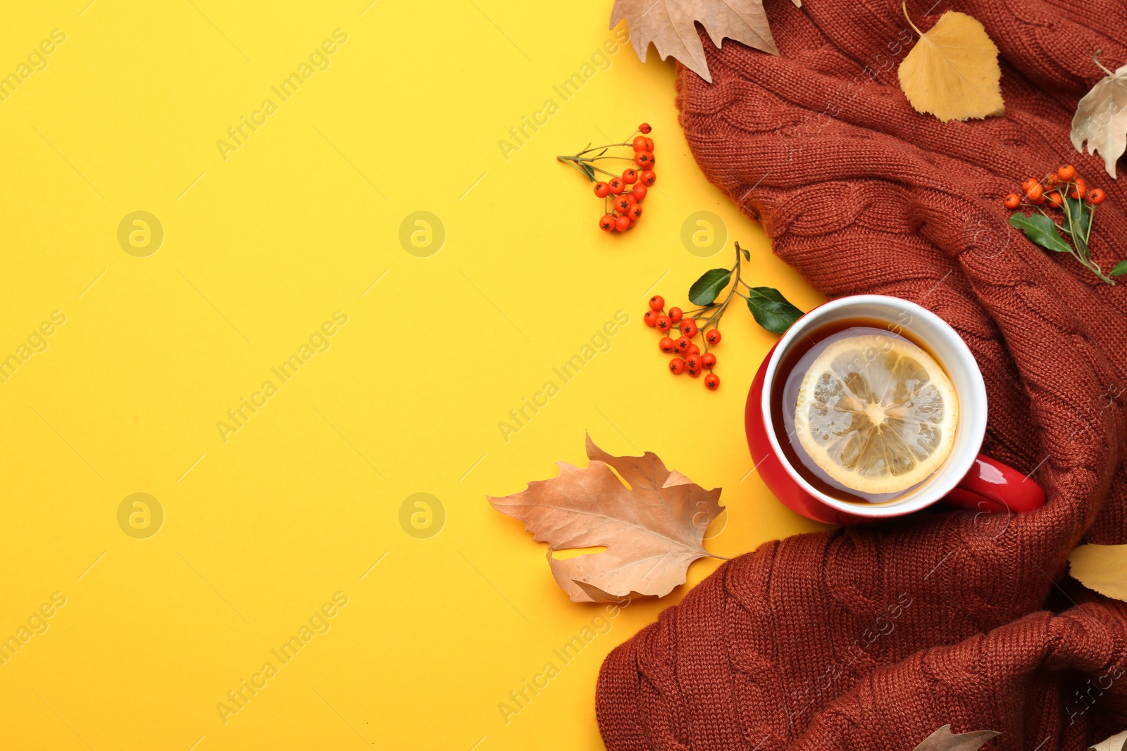 Photo of Flat lay composition with hot drink on yellow background, space for text. Cozy autumn