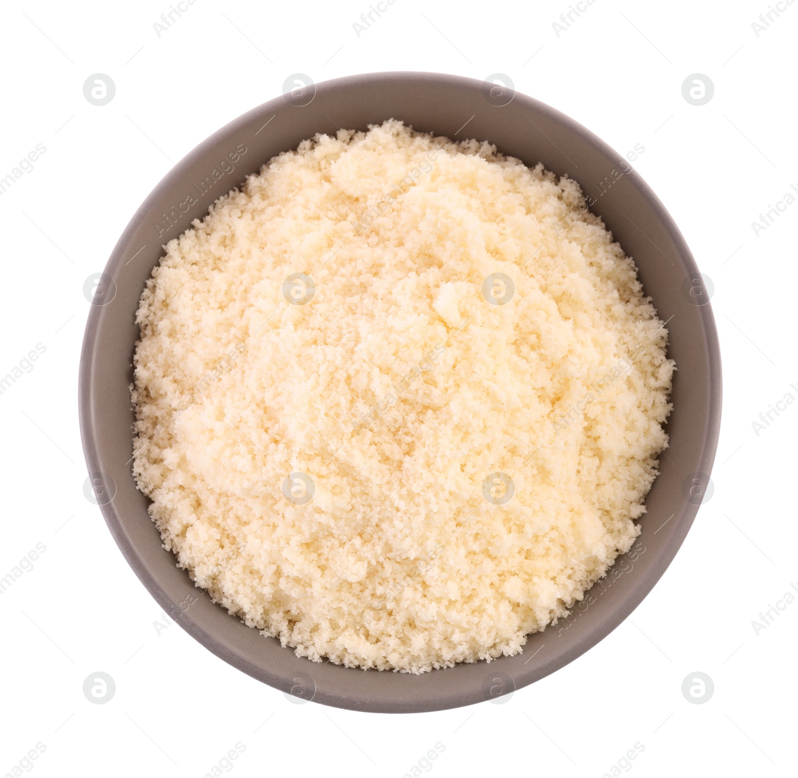 Photo of Delicious grated parmesan cheese in bowl isolated on white, top view