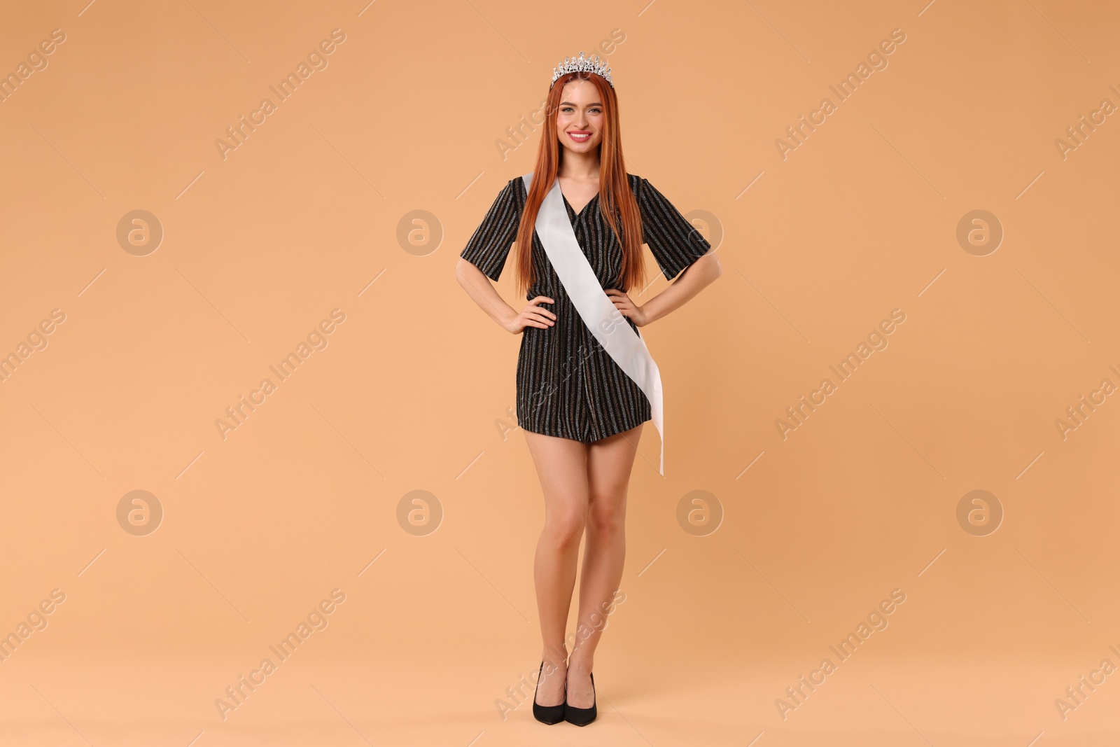 Photo of Beautiful young woman with tiara in dress on beige background