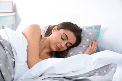 Photo of Young woman sleeping on soft pillow. Bedtime