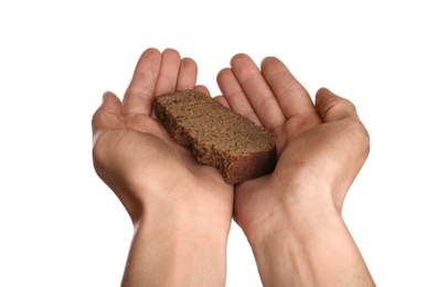 Photo of Poor man holding piece of bread on white background, closeup
