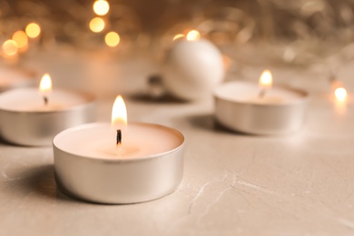 Photo of Beautiful burning wax candle on table, closeup