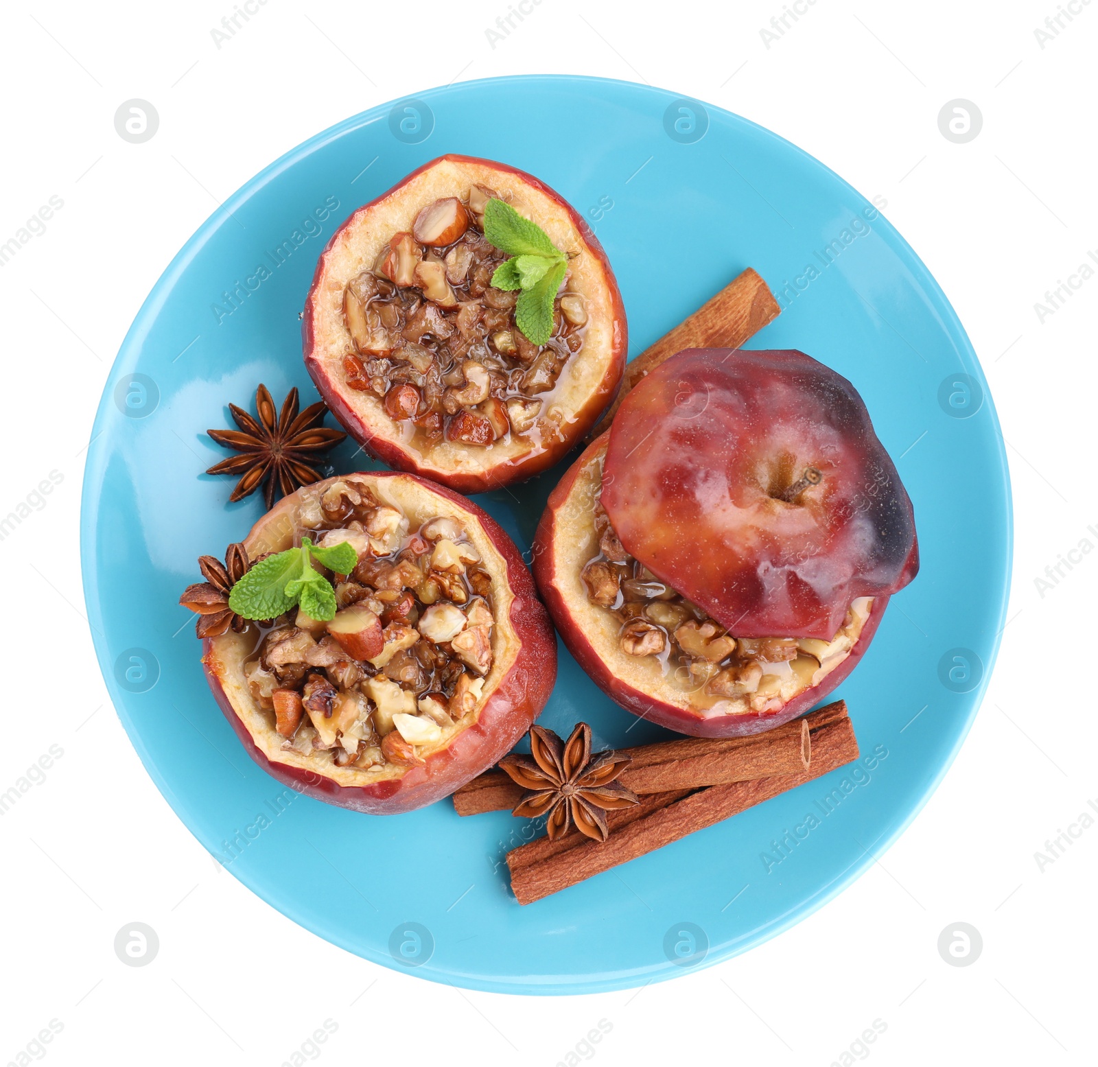 Photo of Tasty baked apples with nuts, honey, spices and mint isolated on white, top view