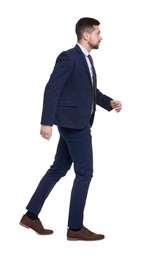 Handsome bearded businessman in suit running on white background