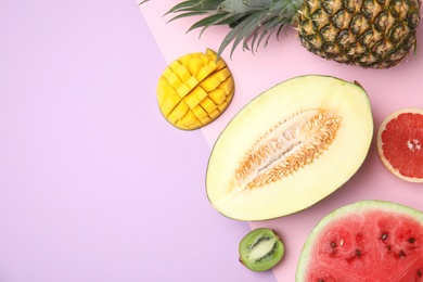 Photo of Flat lay composition with melon, other fruits and space for text on color background