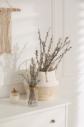Photo of Pussy willow tree branches on white table indoors