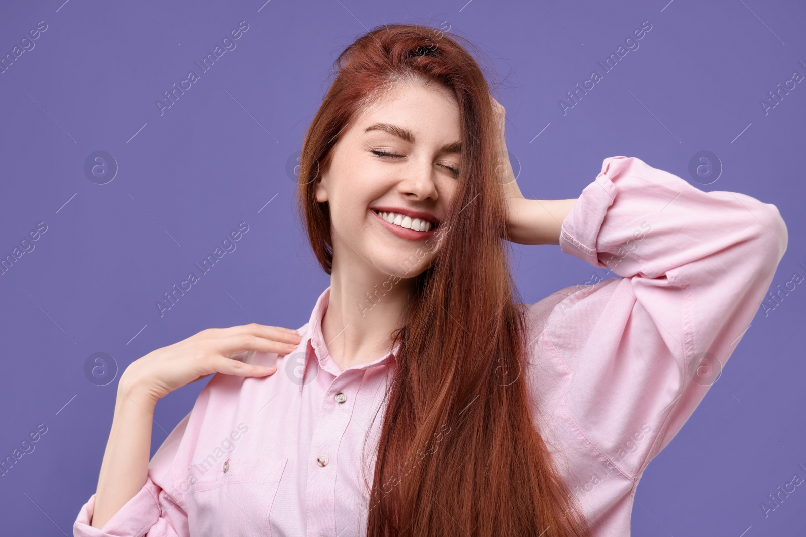 Photo of Portrait of smiling woman on purple background