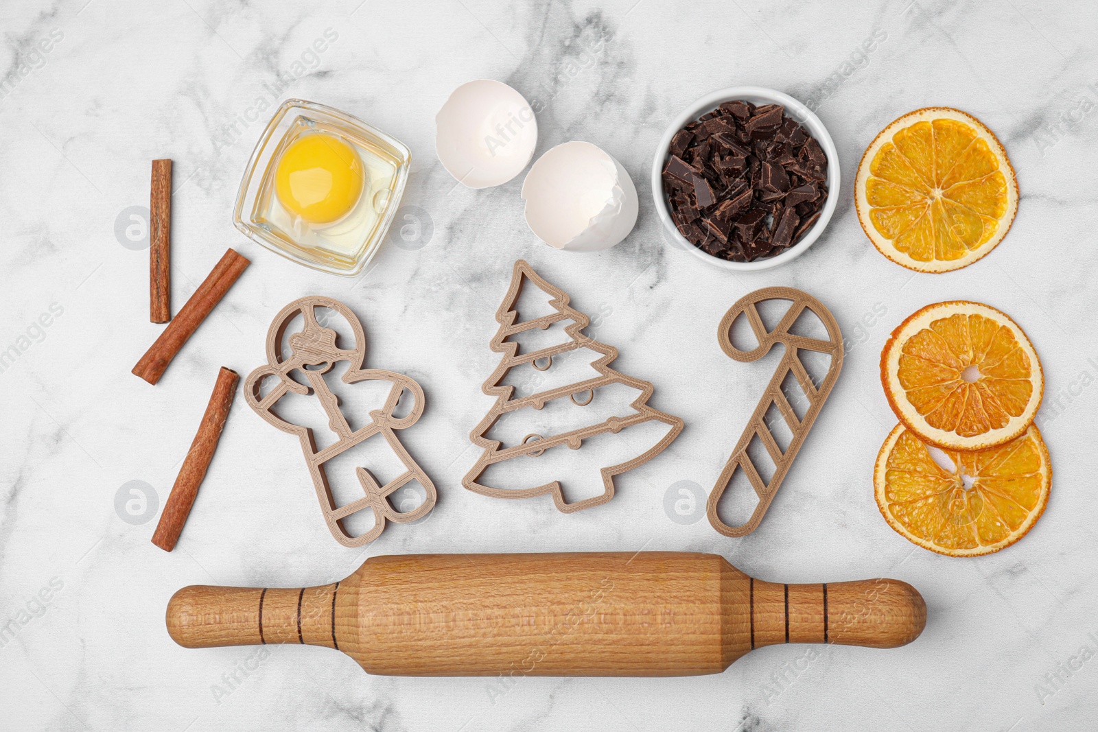 Photo of Flat lay composition with cookie cutters and ingredients on white marble table