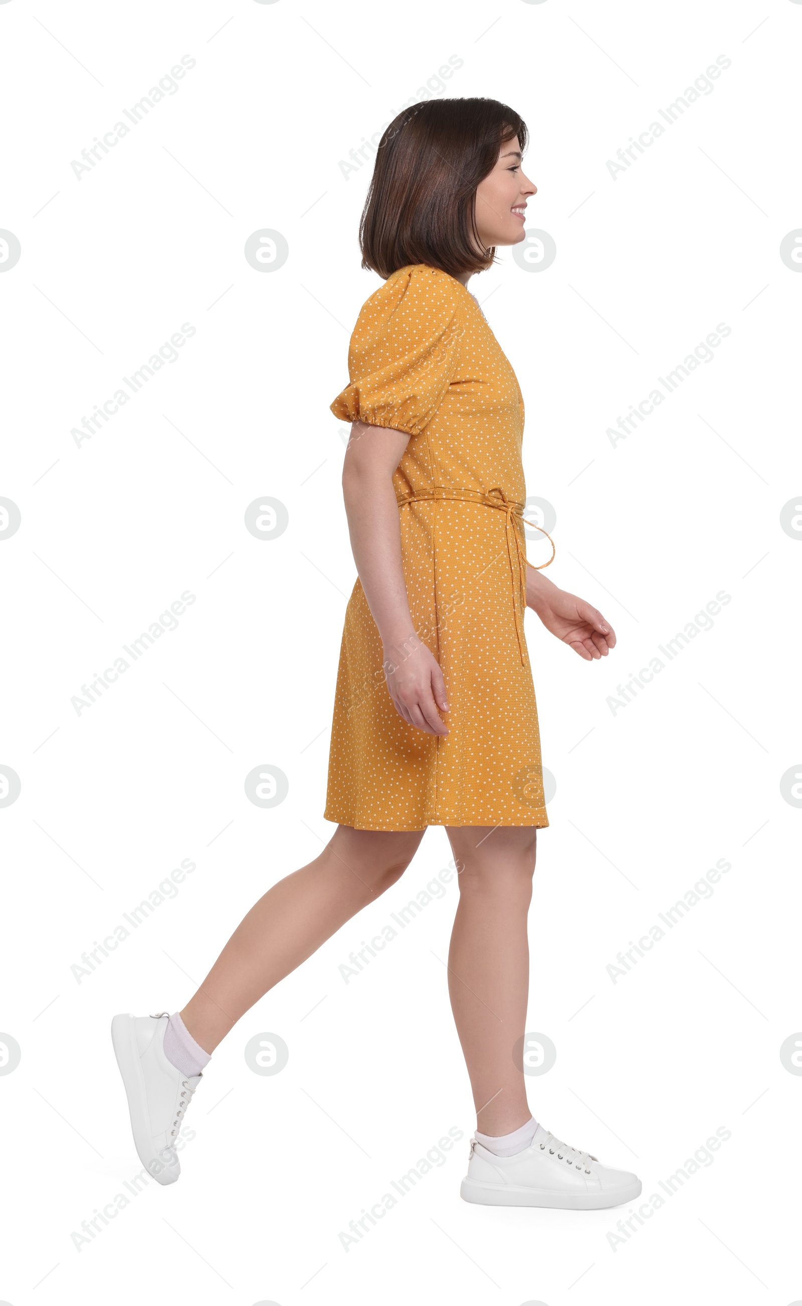 Photo of Happy woman in beautiful dress walking on white background