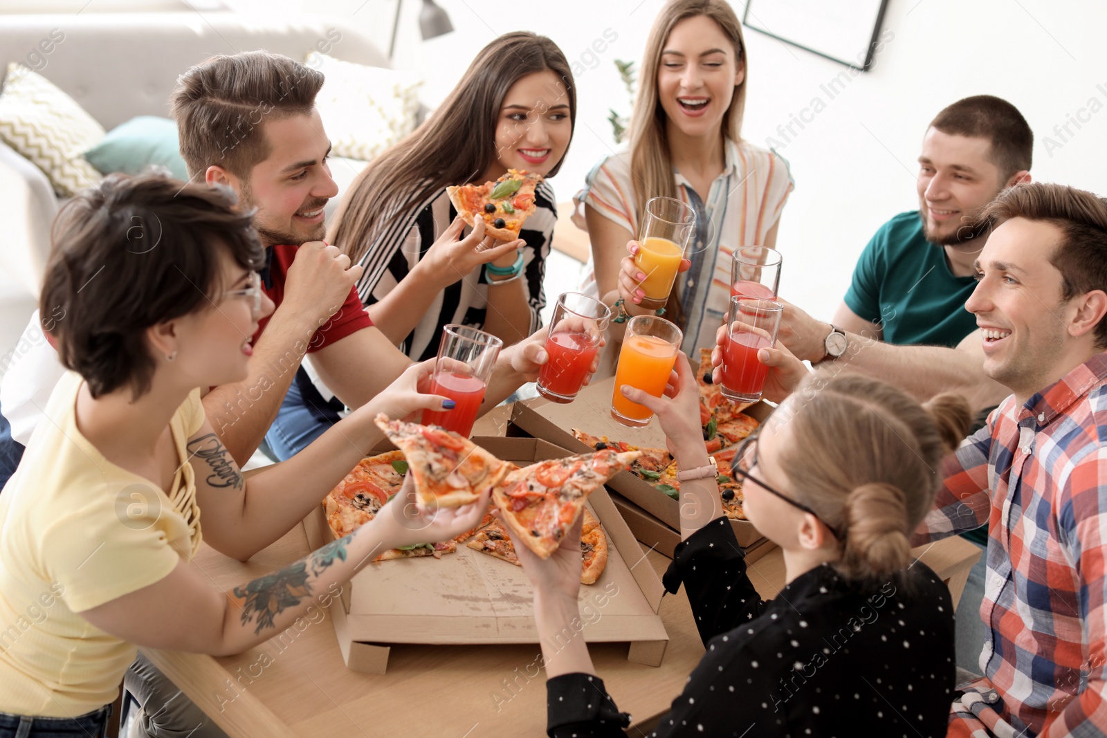 Photo of Young people having fun party with delicious pizza indoors