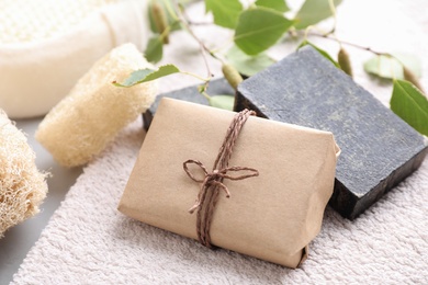 Photo of Natural tar soap on soft towel, closeup