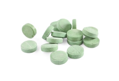 Photo of Pile of green pills on white background