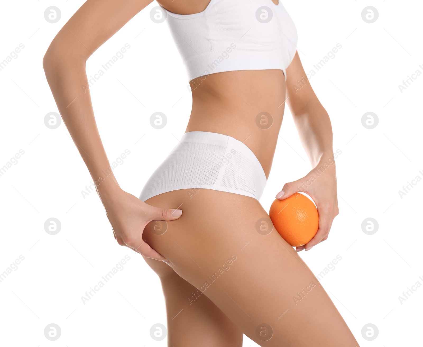 Photo of Closeup view of slim woman in underwear with orange on white background. Cellulite problem concept