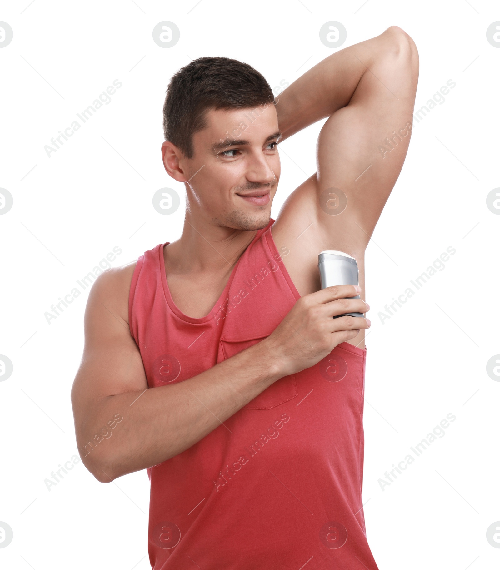 Photo of Young man applying deodorant to armpit on white background