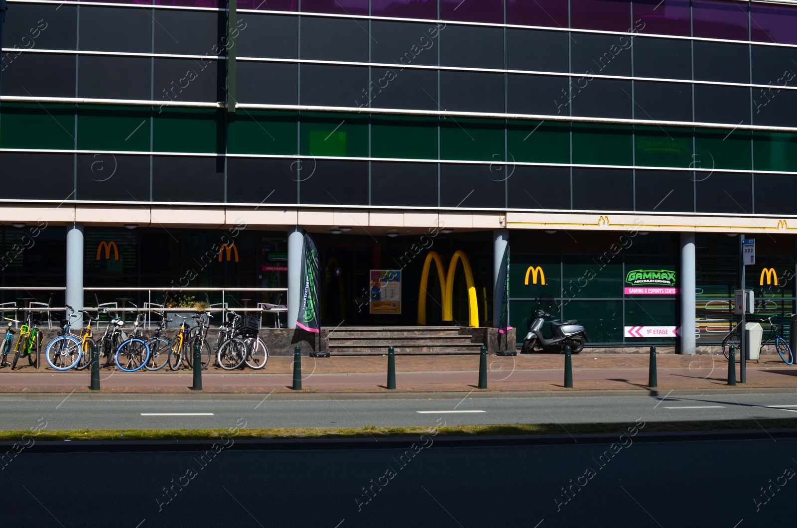 Photo of Hague, Netherlands - May 2, 2022: Exterior of Mcdonald's fastfood restaurant with logo on city street