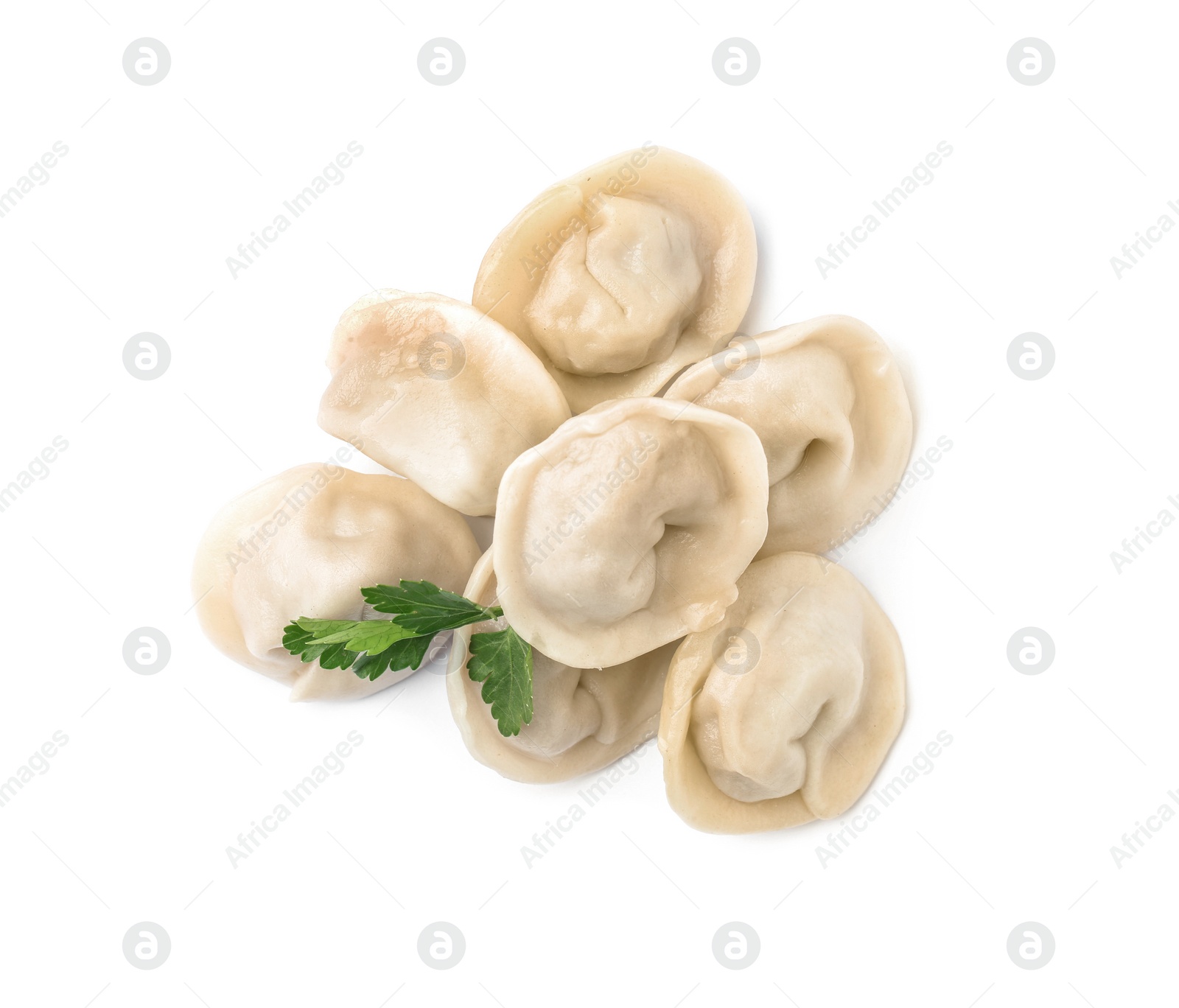 Photo of Pile of boiled dumplings with parsley leaves on white background, top view