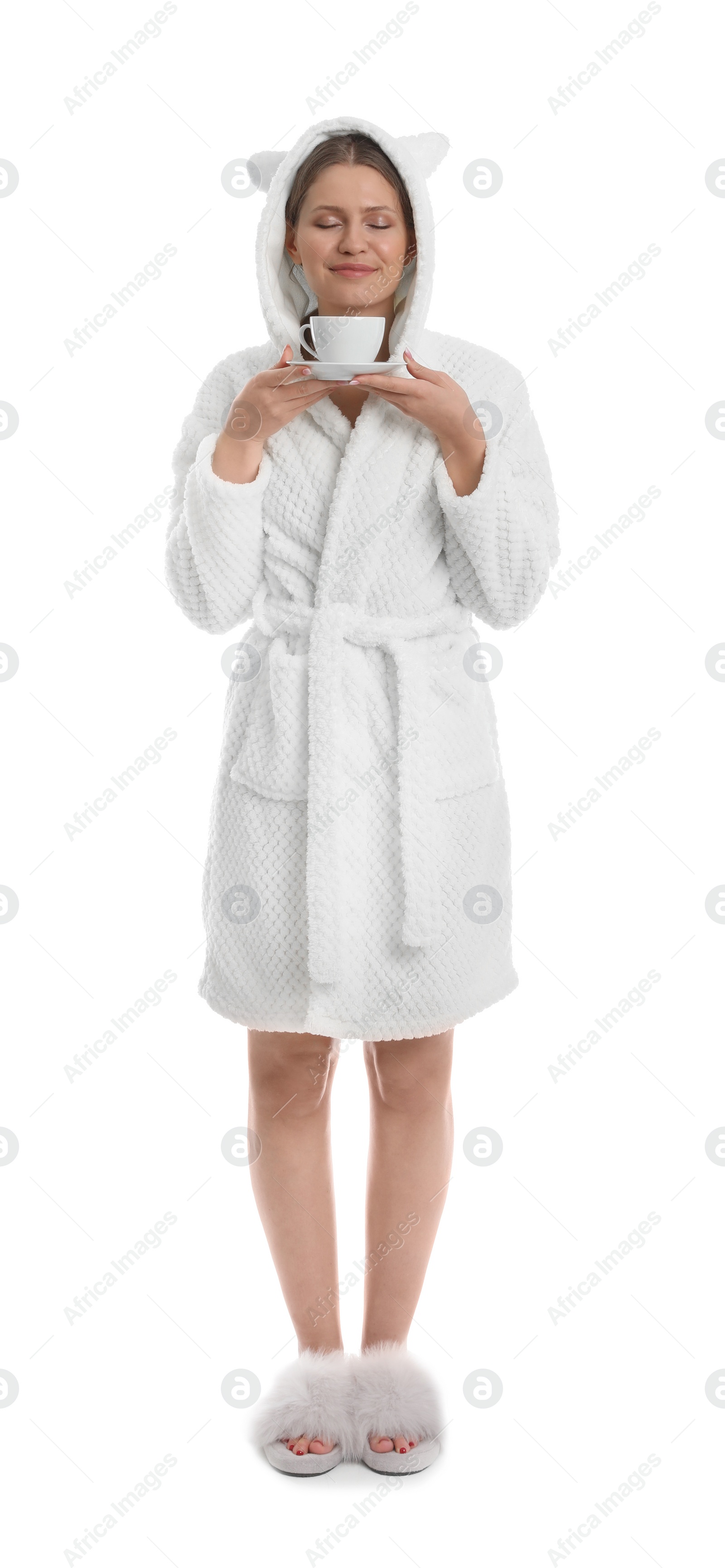 Photo of Young woman in bathrobe with cup of beverage on white background