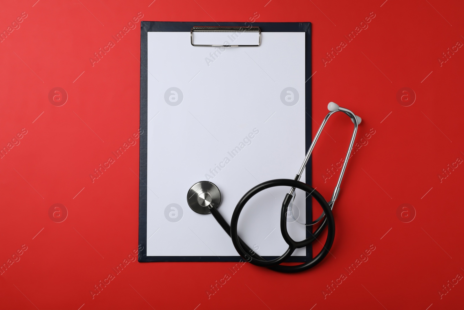 Photo of Clipboard with space for text and stethoscope on color background, top view. Medical objects