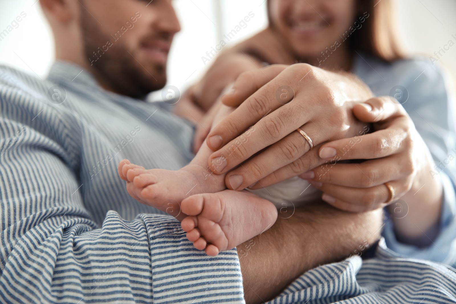 Photo of Happy couple with their newborn baby, closeup