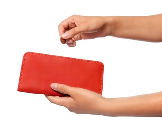 Young woman putting coin into wallet on white background, closeup view