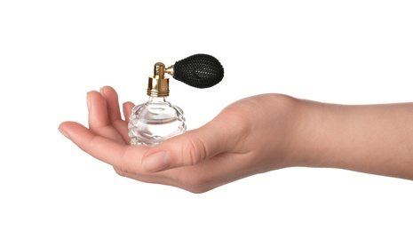 Photo of Young woman holding bottle of luxury perfume on white background, closeup