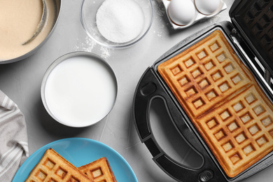 Flat lay composition with fresh Belgian waffles on light grey table