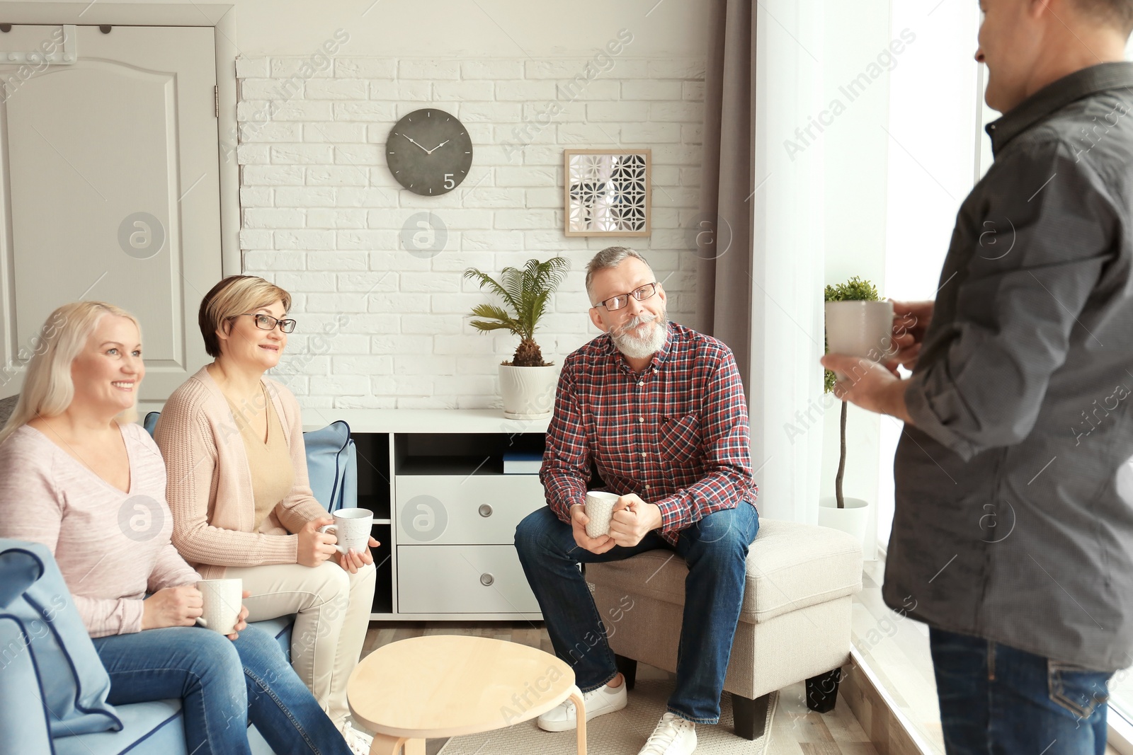 Photo of Happy senior couples spending time together at home