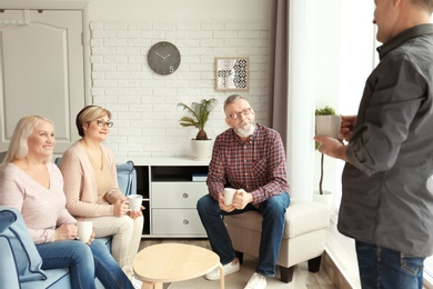 Photo of Happy senior couples spending time together at home